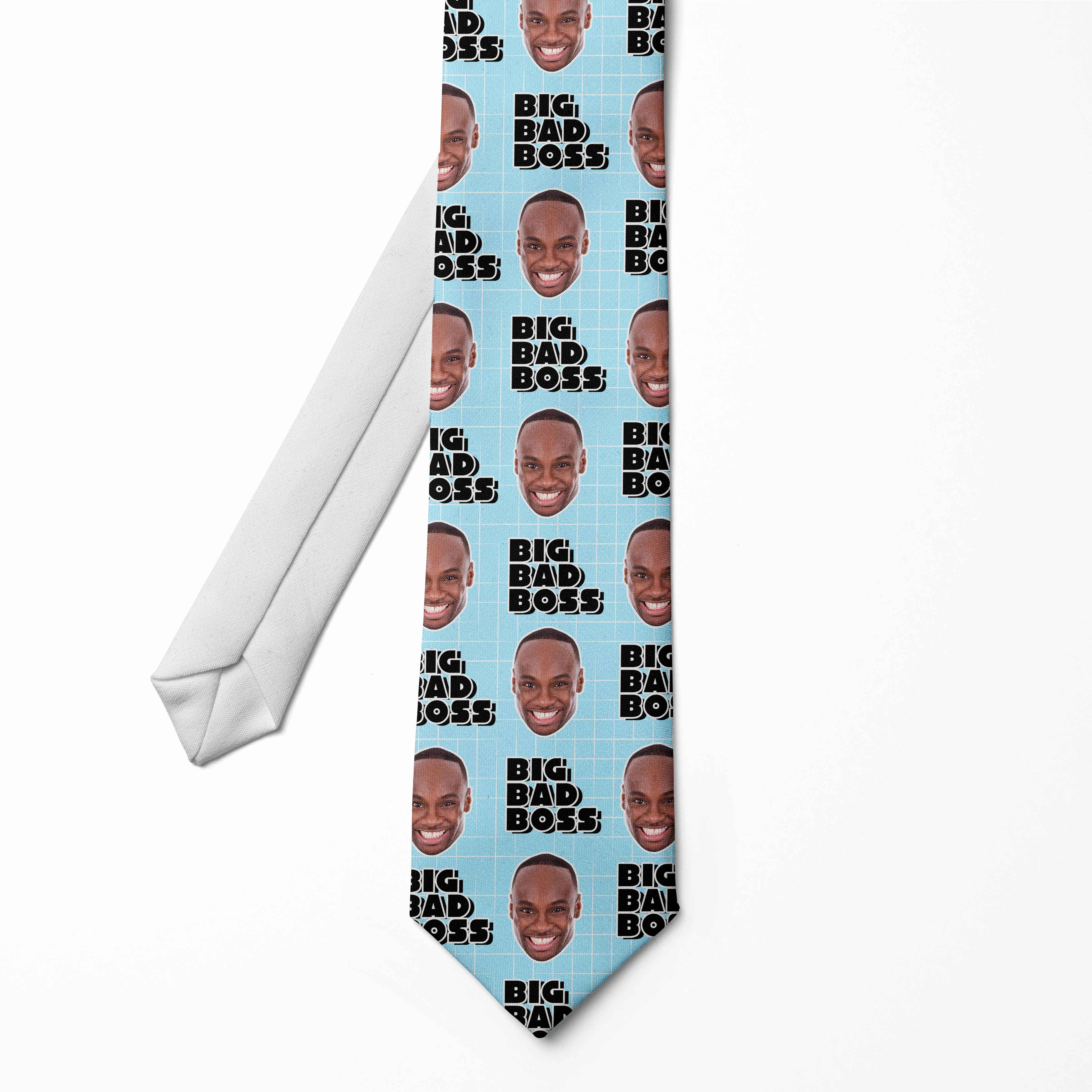 A personalized tie with multiple faces printed on it, with the text 'BIG BAD BOSS' on a light blue background.