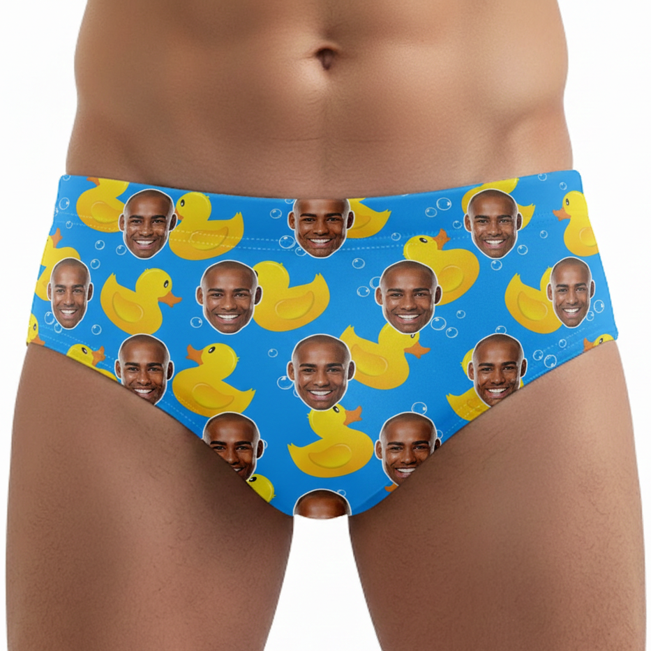 Blue underwear with yellow rubber ducks and faces on a white background